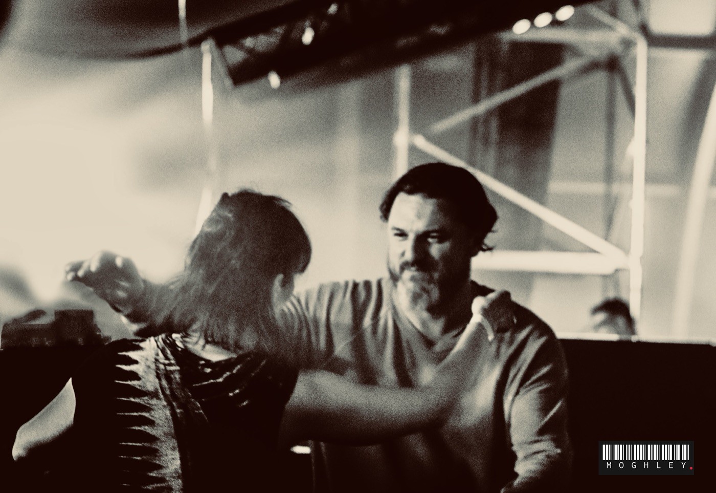 Black and white photograph of two people embracing at an event